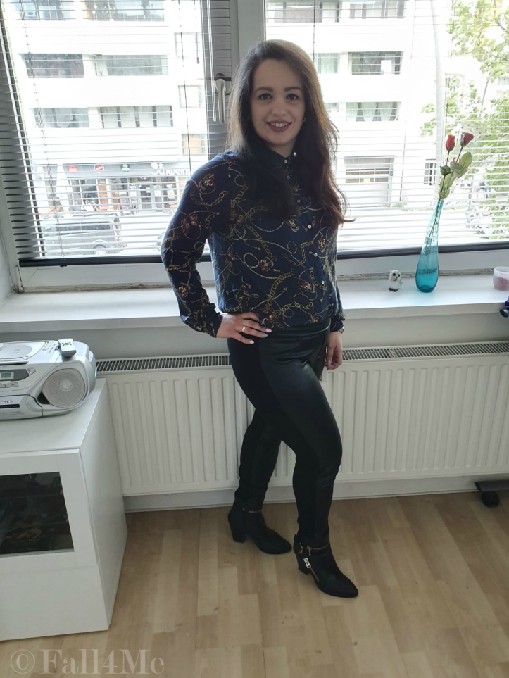 Trendy office chic: A trendy blouse with skinny black pants and boots.