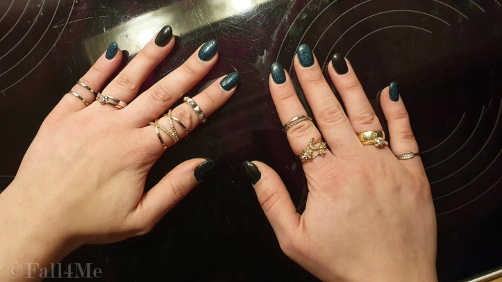 Black nails and black nails with green glitter.