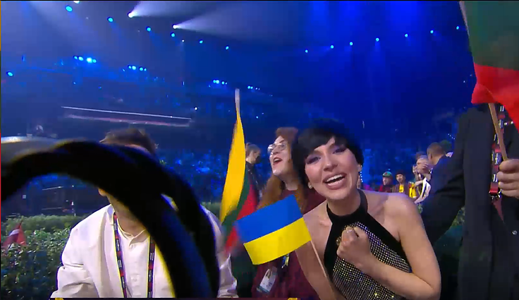 Monika Liu from Lithuania holding the Ukrainian flag.